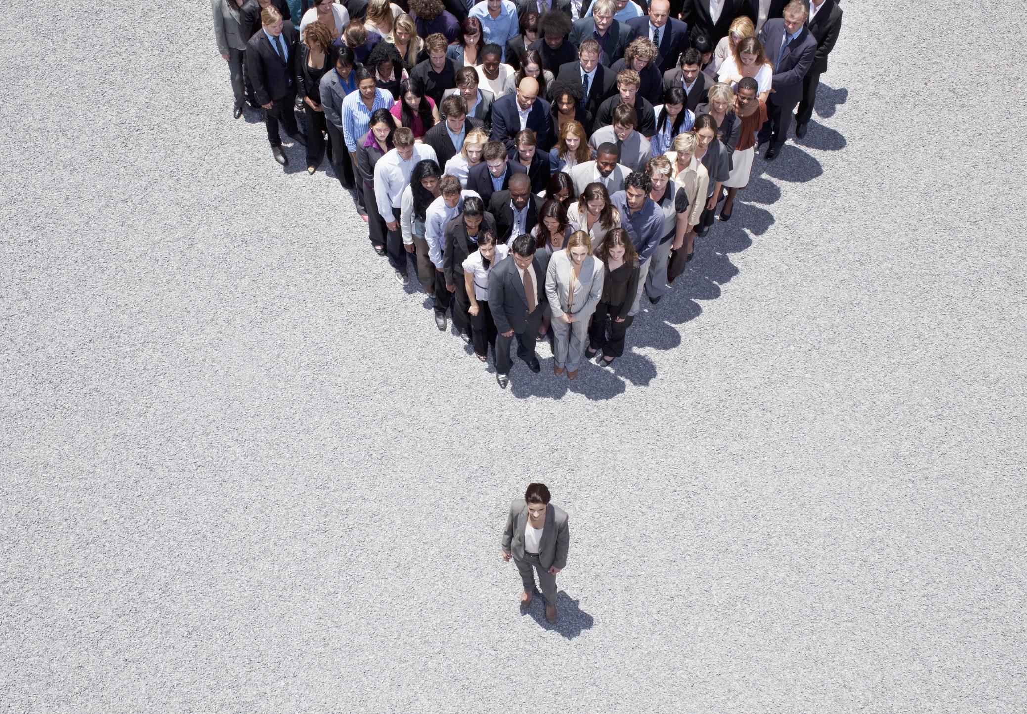 Businesswoman standing in front of her team, leading with influence.